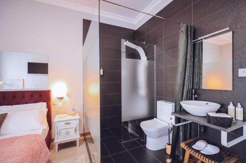 a bathroom with a toilet and a sink at Downtown Loulé in Loulé