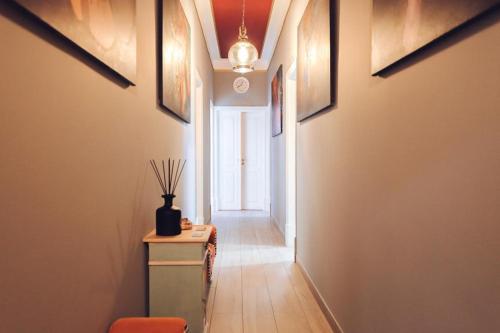 a hallway with a table and a window in a room at Downtown Loulé in Loulé