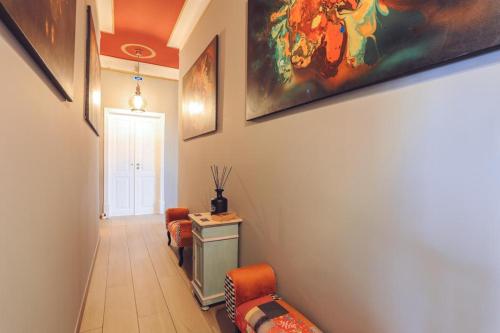 a hallway with two chairs and a painting on the wall at Downtown Loulé in Loulé