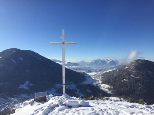 a cross on top of a snow covered mountain at BAITA NONNO GHINO in Bedollo