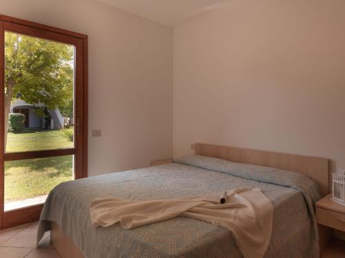 Un pat sau paturi într-o cameră la Apartment Le Dimore di Budoni-2 by Interhome