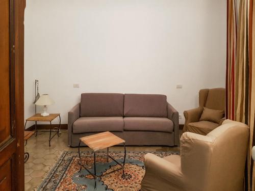 een woonkamer met een bank en een stoel bij Apartment Tristano - FLG214 by Interhome in Finale Ligure