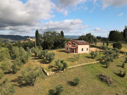 a small house in the middle of a field at Holiday Home La Rocchetta by Interhome in Montescudaio