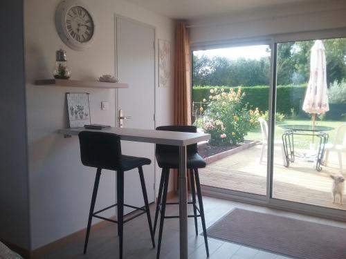 a kitchen with a table and chairs and a window at Chez claudine in Favières