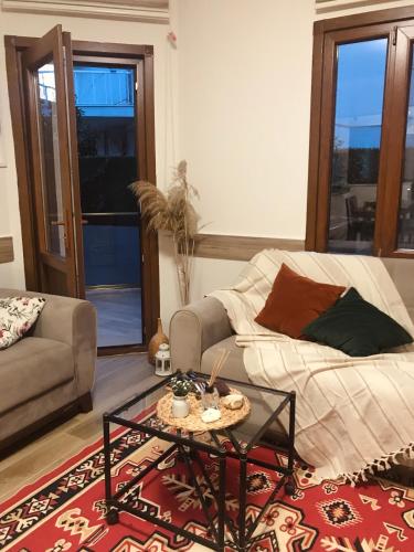 a living room with a couch and a coffee table at İberia Villas in Ortaca