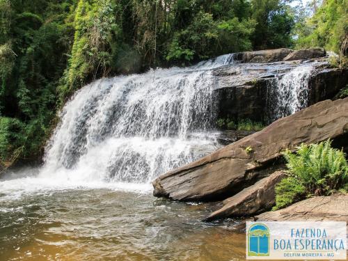 a waterfall on the side of a river at Hotel Fazenda Boa Esperança in Delfim Moreira