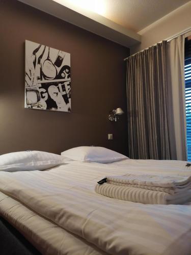 a large white bed in a bedroom with a window at Tahko Spa Suite B3 in Tahkovuori