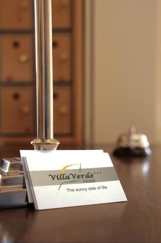 a white card sitting on top of a table at Hotel Villa Verde in Düsseldorf