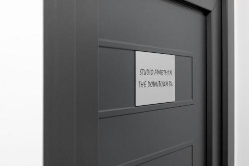 a door with a sign on it with a sign on it at Apartman DOWNTOWN DL in Zagreb