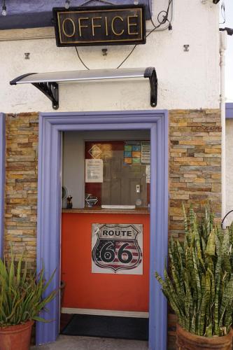 a front door of a coffee shop with a sign above it at Route 66 Motel - Rialto in Rialto