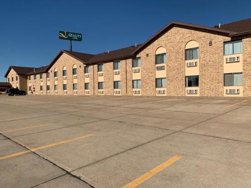 an empty parking lot in front of a large building at Quality Inn in North Platte