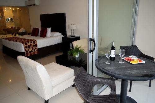 a hotel room with a bed and a table and chairs at Sun Hotel in Santa Cruz de la Sierra