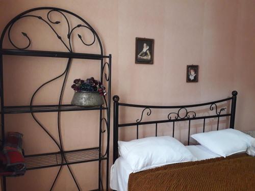 a bedroom with two beds and a flower pot on the wall at Nana's Guest House in Sighnaghi