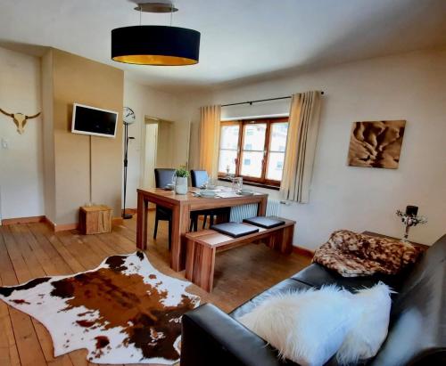 a living room with a couch and a table at Kitzbühel Apartments Haus Brugger in Kitzbühel