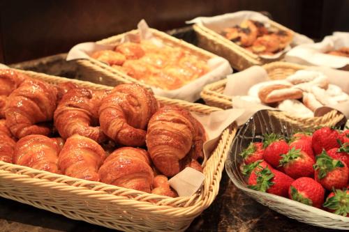a bunch of baskets of pastries and strawberries on a table at Insotel Fenicia Prestige Suites & Spa in Santa Eularia des Riu