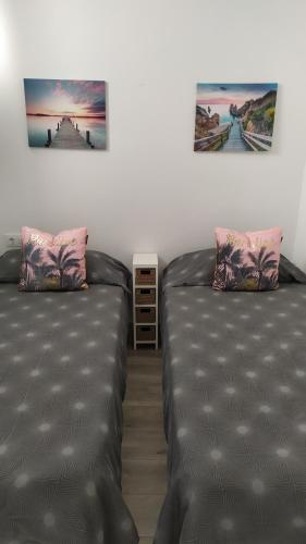 two beds sitting next to each other in a room at Apartment Island Paradise in Adeje