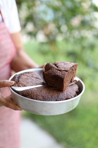 a person holding a plate of chocolate cake at Locanda Dell' Orso Bevitore in Verduno