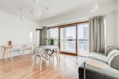 a living room with a couch and a table at Tapiola Oak Apartment in Espoo