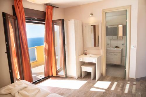 a bedroom with a bed and a view of the ocean at PORTO TIMONI in Afionas