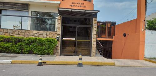 a front door of a building with cones in front of it at Residencial Solar de Pernambuco in Guarujá