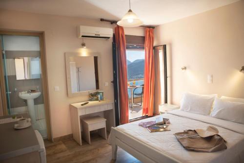 a bedroom with a bed and a bathroom with a window at PORTO TIMONI in Afionas