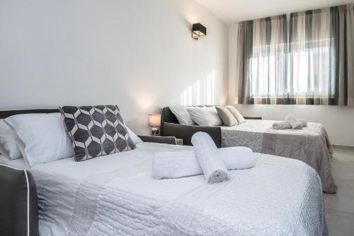 a bedroom with two beds and a couch at COZY studio-flat in PACEVILLE in St. Julianʼs