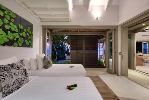 een slaapkamer met 2 bedden en een groot raam bij The Headland Villa 2, Samui in Koh Samui 