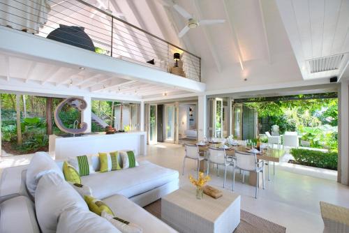 an open living room with a white couch and chairs at The Headland Villa 2, Samui in Koh Samui