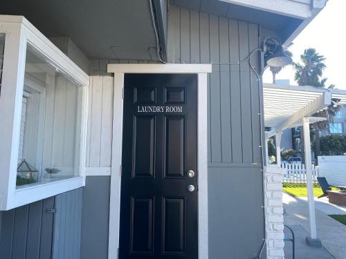 a black front door of a house with a library room at Steps To The Beach, Main Street and Pacific City - OCEAN VIEWS in Huntington Beach