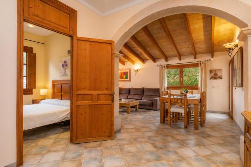 a bedroom and living room with a bed and a table at Casa Manolo in Cala Ratjada
