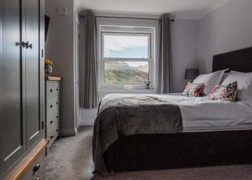 a bedroom with a large bed and a window at Number Seven in Newquay