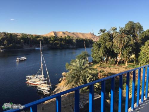 a boat is docked in a river next to a bridge at Nubian Lotus in Aswan