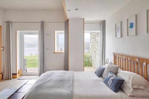 a bedroom with a bed with a view of the ocean at Seaview in Llandegfan