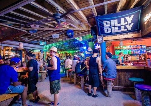 a group of people standing at a bar at Capt Hirams Resort in Sebastian
