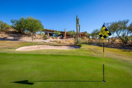 a golf course with a hazard sign on a green at Wekopa Casino Resort in Fountain Hills