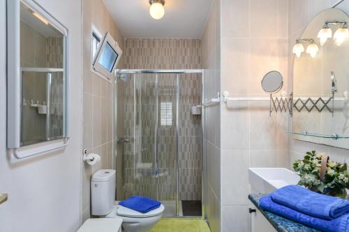 a bathroom with a shower and a toilet and a sink at Casa Conchita in Playa Honda