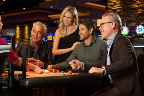 a group of people playing poker in a casino at Wekopa Casino Resort in Fountain Hills