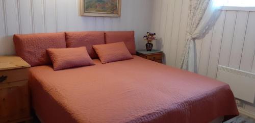 a bed with two pillows on it in a room at Irina & Paul House at Krokedal in Fetsund