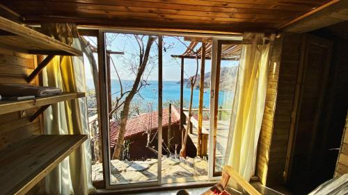 a window in a room with a view of the ocean at Hotel Cactus Taganga in Taganga