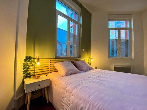 een slaapkamer met een wit bed en 2 ramen bij Charmant T2 Hyper-centre, Netflix, Gare in Amiens