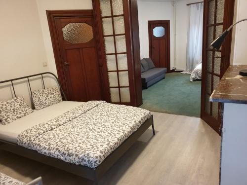 a bedroom with a bed and a living room at 1-2 bedroom apartments close to EU district. in Brussels