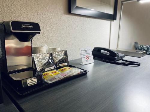 a black phone sitting on top of a desk at Ramada by Wyndham Hartford North - Bradley Airport in Windsor Locks