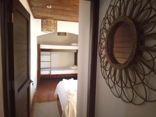 a mirror on a wall next to a bedroom at Macao Beach in Sámara