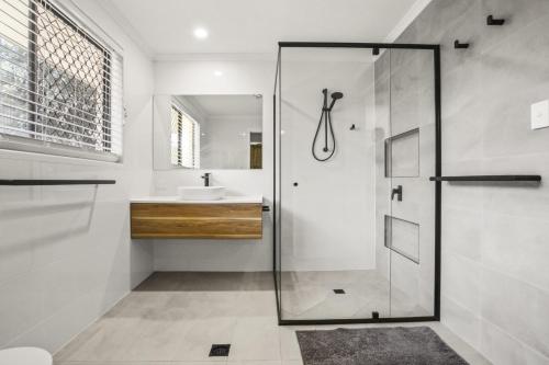 a bathroom with a shower and a sink at Lakeshores 41 Coongarra in Kawana Waters