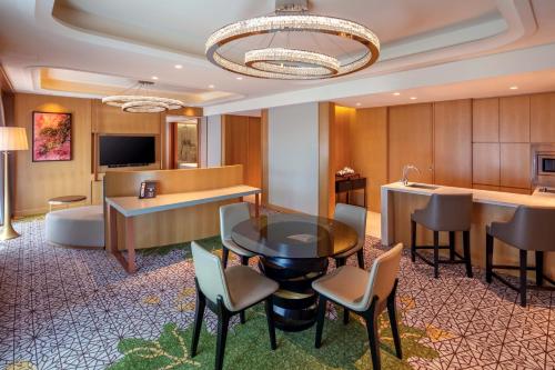 a hotel room with a table and chairs and a couch at PARKROYAL on Beach Road, Singapore in Singapore