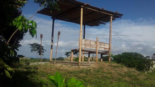 a wooden pavilion on top of a hill at biohotel tatacoa Qji in Villavieja