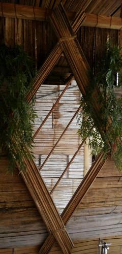 a wooden ceiling with some plants on it at biohotel tatacoa Qji in Villavieja