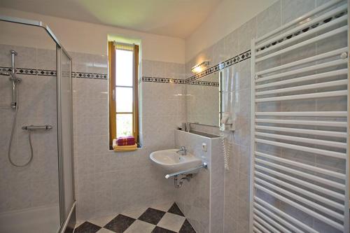 a bathroom with a sink and a shower at Pension Lindenhof in Deutschfeistritz