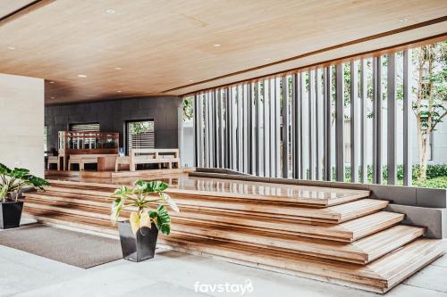 a house with wooden stairs and a dining room at 23 Degrees Khao Yai by Favstay in Phayayen