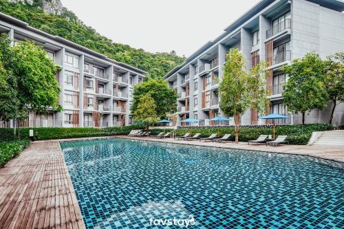 a swimming pool in front of a building at 23 Degrees Khao Yai by Favstay in Phayayen